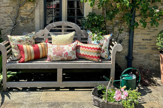 Outdoor bench with colorful pillows in a garden setting