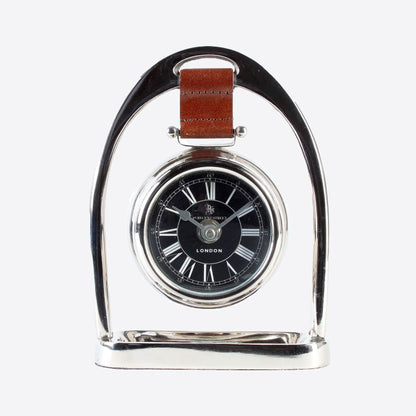 silver stirrup with chestnut leather strap holding hanging clock