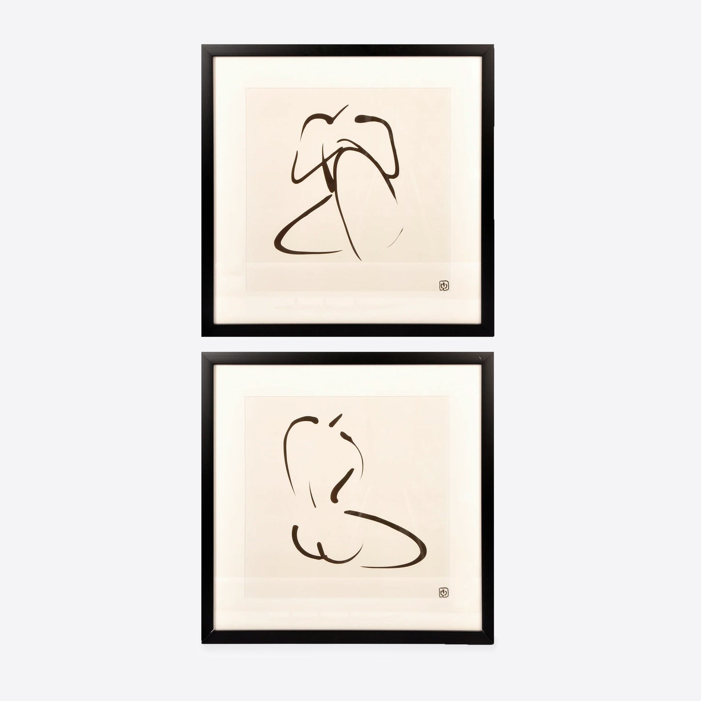 two framed prints of black and white nudes