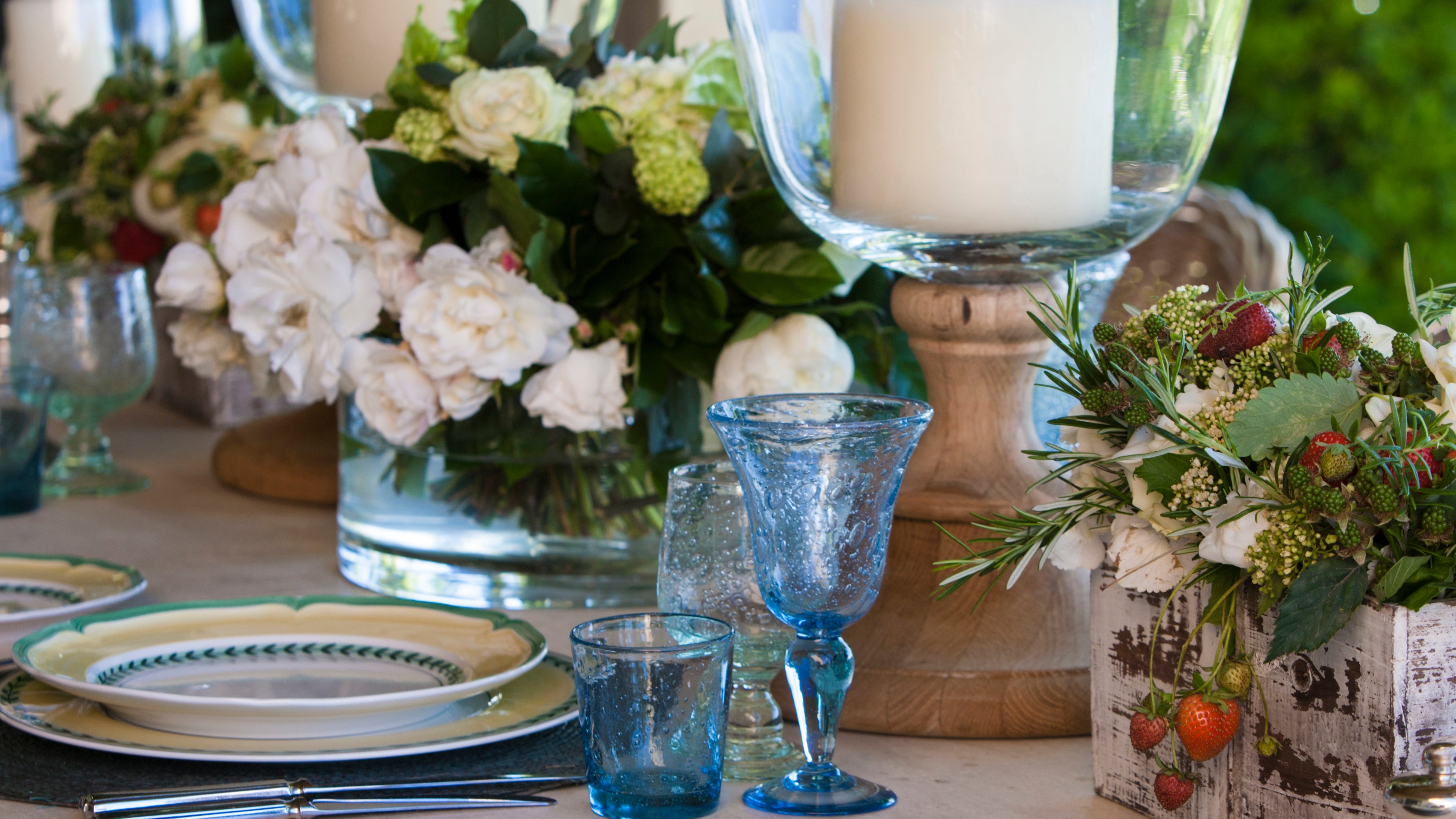 Table laid with blue wine glass and blue tumbler