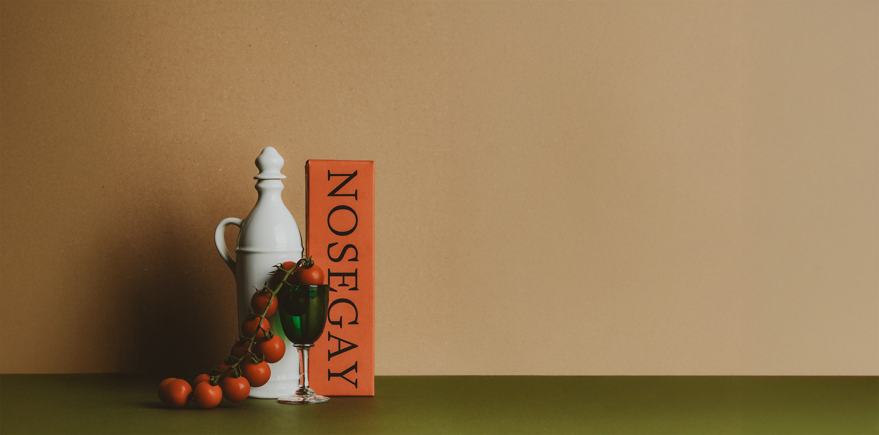 Decorative bottle and box labeled 'Nosegay' on a brown background
