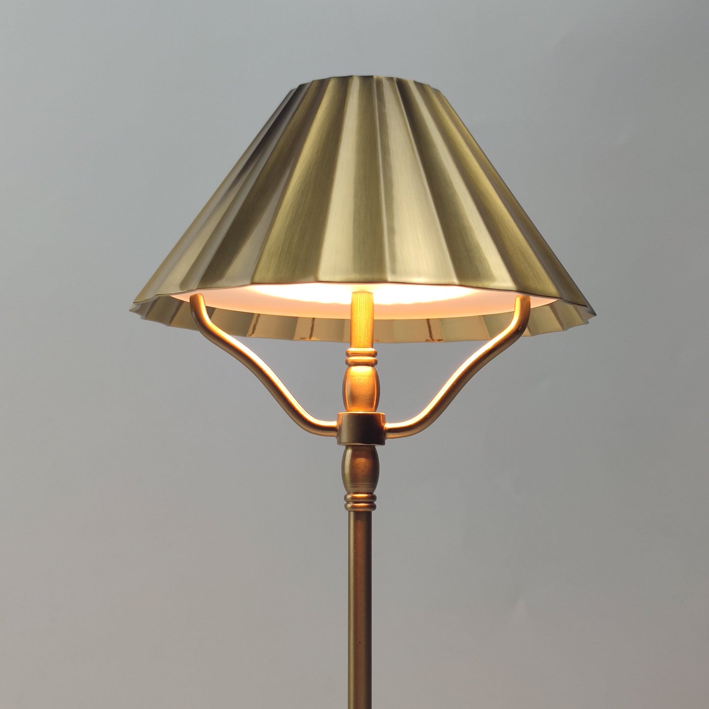 Close up of brass shade with pleated effect
